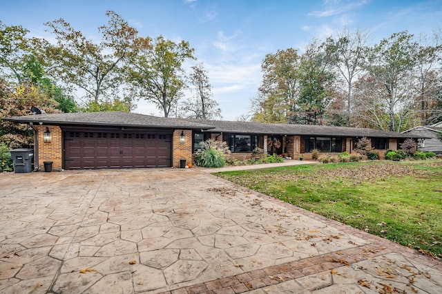 ranch-style house with a garage and a front lawn