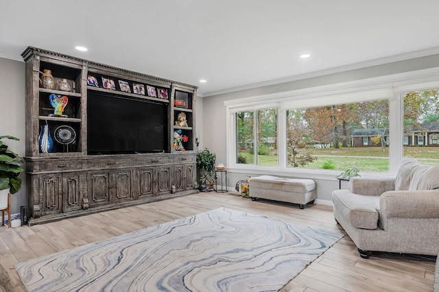 living room featuring light hardwood / wood-style flooring and ornamental molding