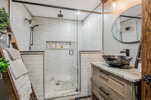 bathroom featuring vanity and a shower with shower door