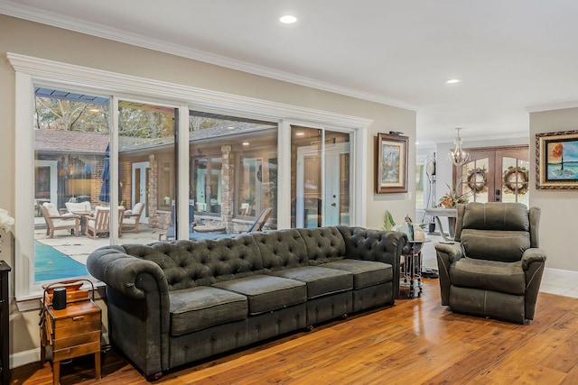 living room with wood-type flooring, french doors, and crown molding