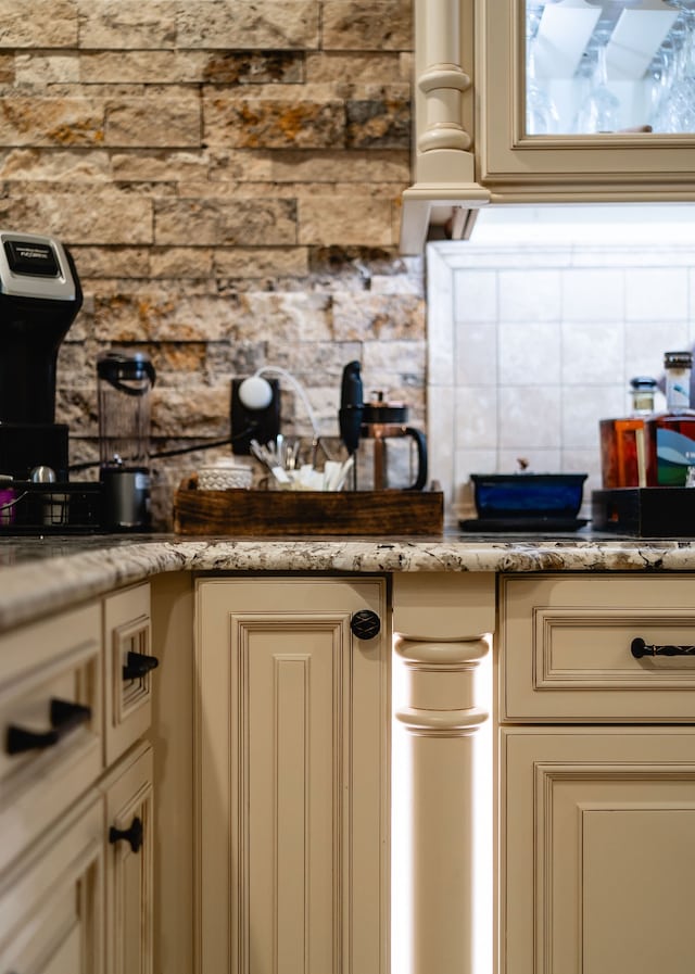 kitchen featuring cream cabinetry and backsplash
