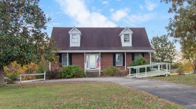 cape cod home with a front yard