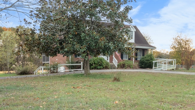 view of property hidden behind natural elements featuring a front yard