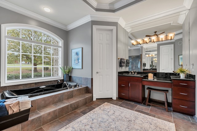 bathroom with tiled tub, vanity, and crown molding