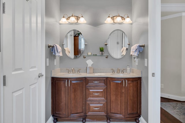 bathroom featuring hardwood / wood-style floors, vanity, and crown molding