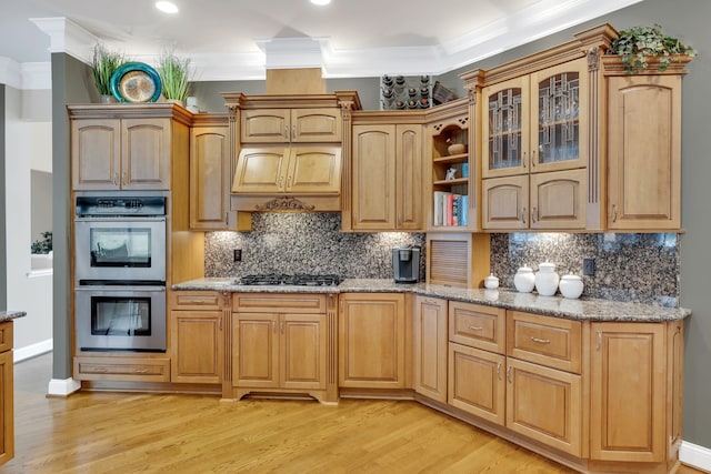 kitchen featuring appliances with stainless steel finishes, crown molding, and light hardwood / wood-style flooring