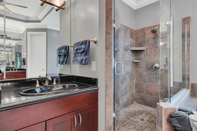 bathroom featuring walk in shower, ornamental molding, and vanity