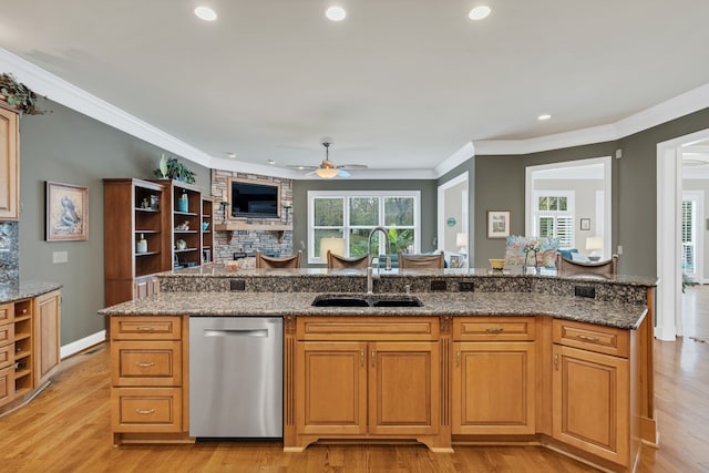 kitchen featuring light hardwood / wood-style floors, stone counters, sink, and dishwasher