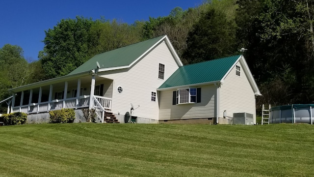 back of house with a lawn and a porch