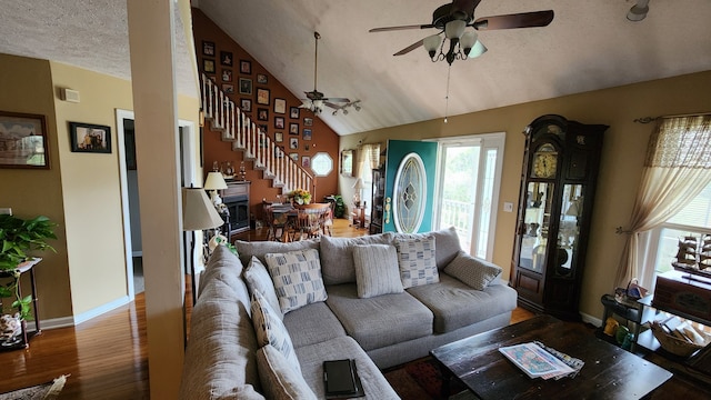 living room featuring high vaulted ceiling, a textured ceiling, hardwood / wood-style flooring, and ceiling fan