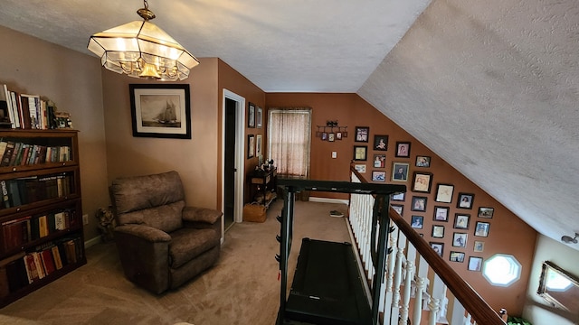 interior space with lofted ceiling, a textured ceiling, and a notable chandelier