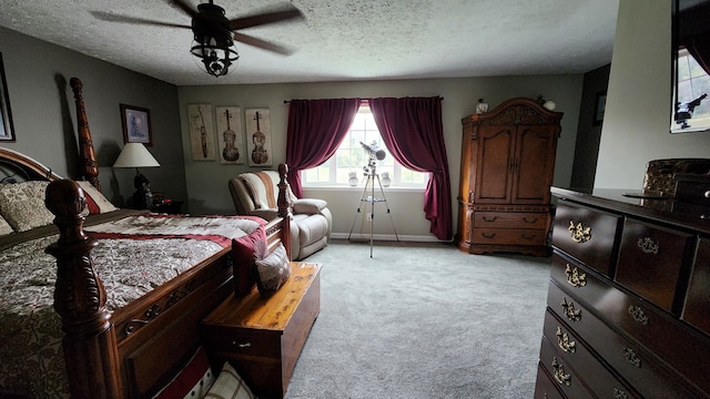 bedroom featuring a textured ceiling, light carpet, and ceiling fan