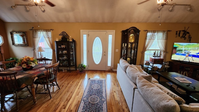 living room with light wood-type flooring and ceiling fan