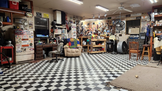 misc room featuring a workshop area and ceiling fan