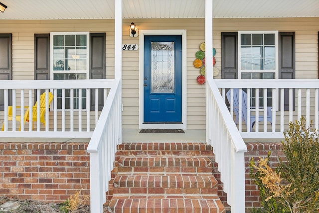 doorway to property with covered porch