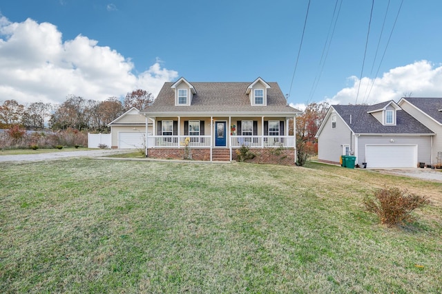 cape cod home featuring covered porch and a front lawn