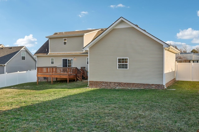 back of house featuring a yard and a deck