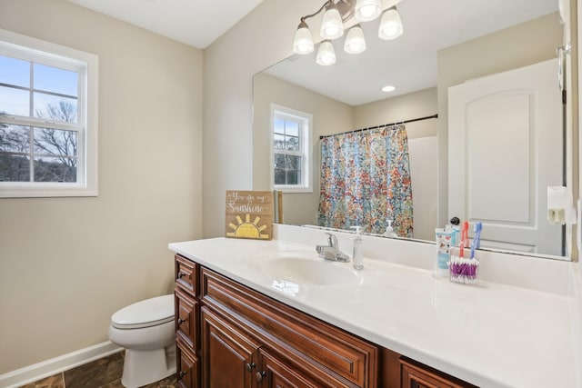 bathroom with vanity, toilet, plenty of natural light, and curtained shower