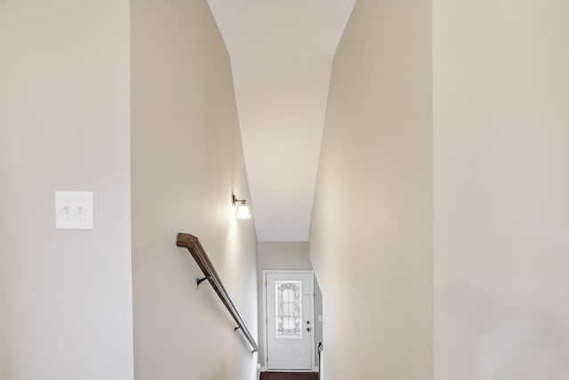 staircase featuring lofted ceiling