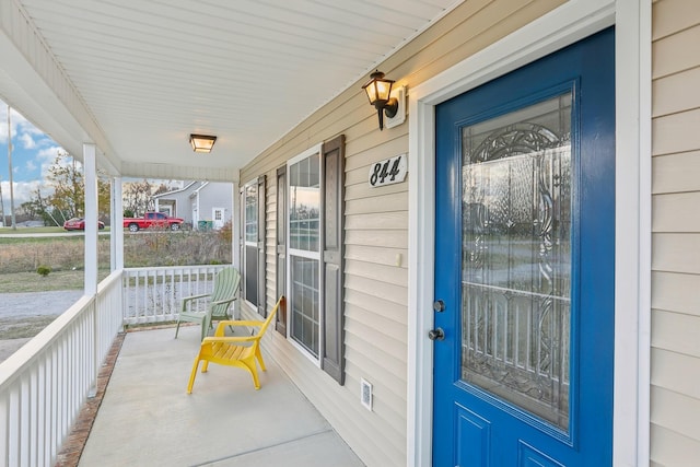 entrance to property featuring covered porch