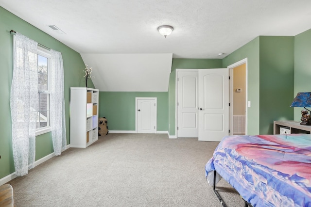 carpeted bedroom with vaulted ceiling