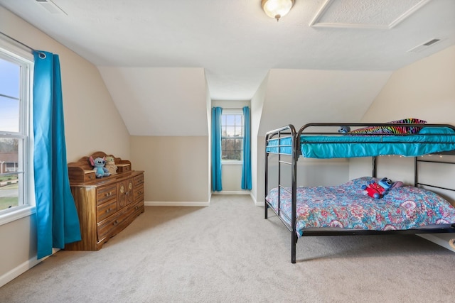 carpeted bedroom with lofted ceiling