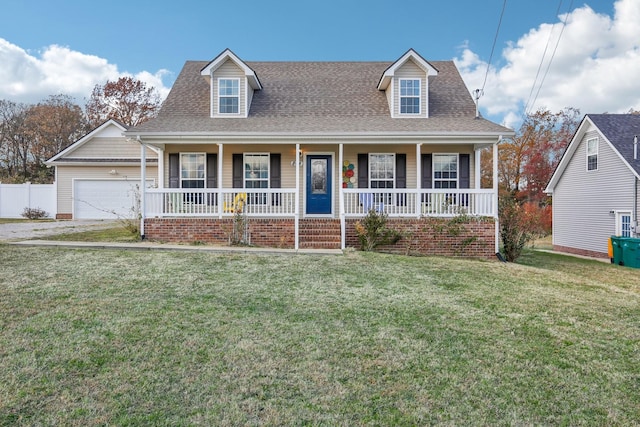 cape cod house featuring covered porch, a garage, and a front lawn