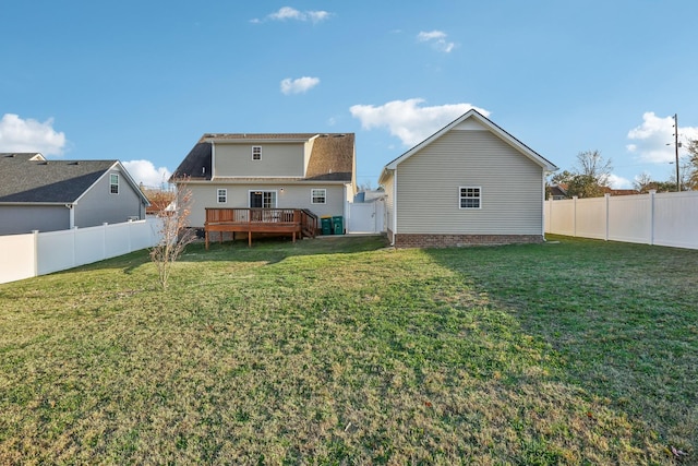 back of house featuring a yard and a deck