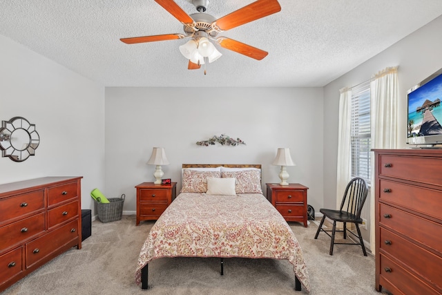 carpeted bedroom featuring ceiling fan and a textured ceiling