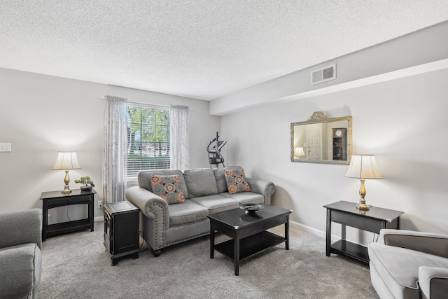 carpeted living room featuring a textured ceiling