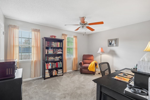 office with a textured ceiling, light colored carpet, and ceiling fan