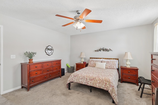 carpeted bedroom featuring a textured ceiling and ceiling fan