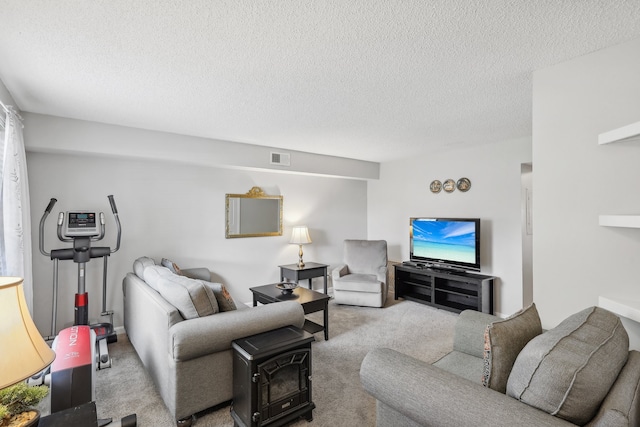 carpeted living room featuring a textured ceiling