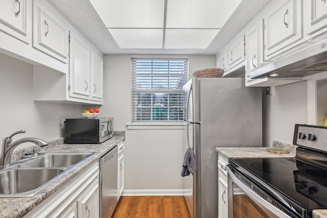 kitchen featuring sink, light hardwood / wood-style floors, white cabinetry, and appliances with stainless steel finishes