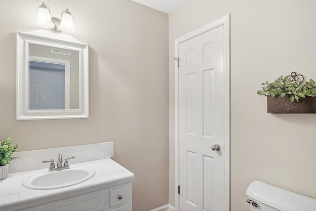 bathroom featuring toilet and vanity