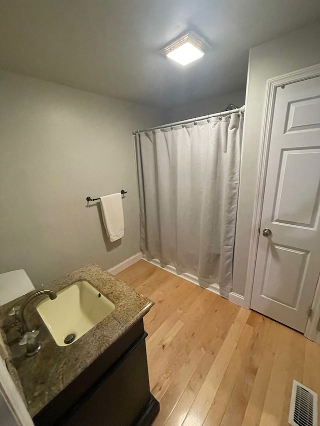 bathroom featuring hardwood / wood-style floors and vanity