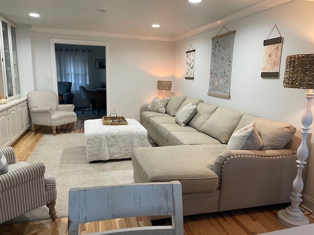 living room with light hardwood / wood-style floors and crown molding