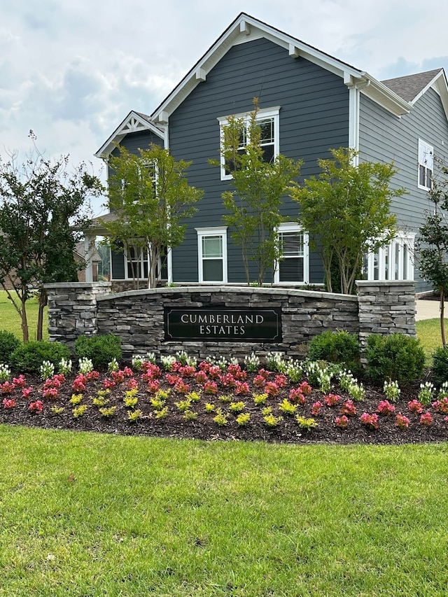 community sign featuring a lawn