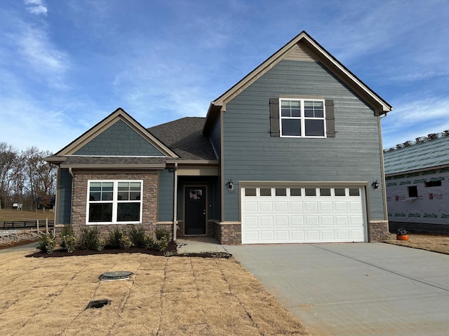 9025 Ada Way, Fairview, TN 37062 - craftsman-style home with stone siding, a garage, and driveway