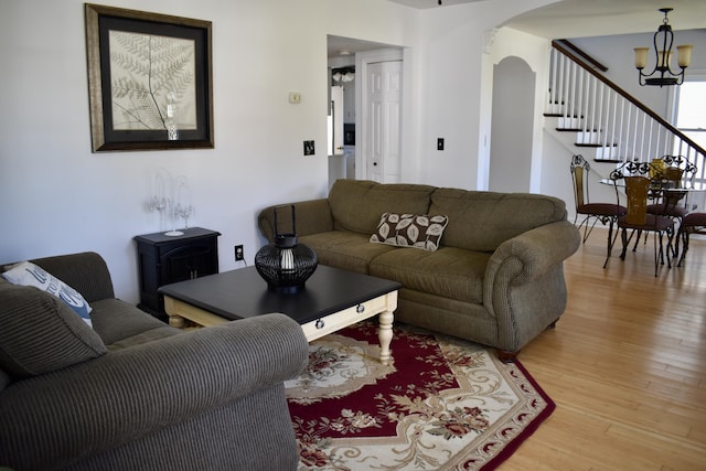 living room with light hardwood / wood-style floors and a chandelier