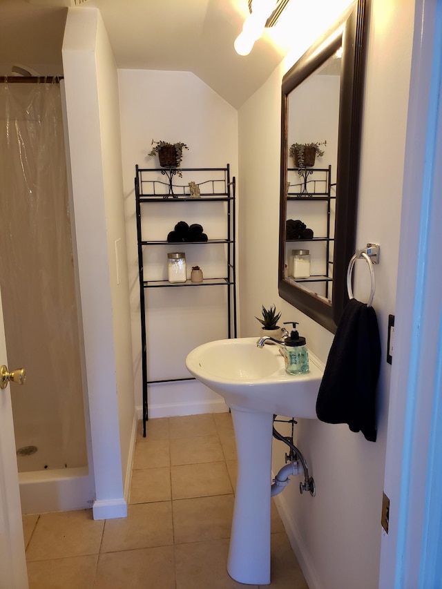 bathroom featuring tile patterned floors, curtained shower, and vaulted ceiling