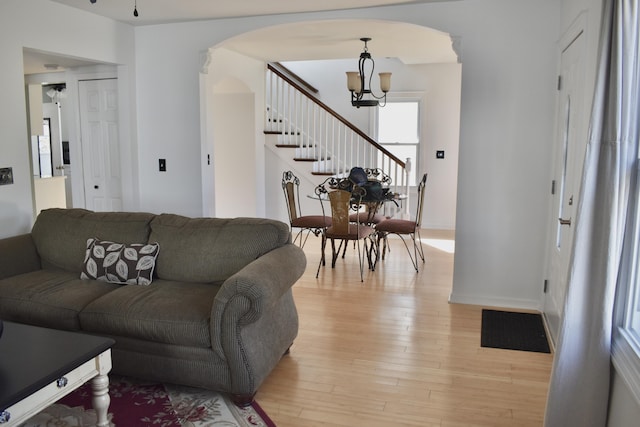 living room featuring light hardwood / wood-style flooring and a notable chandelier