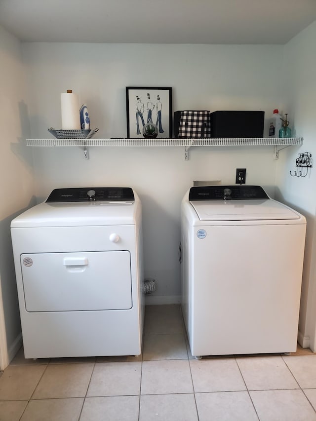 laundry area with light tile patterned floors and independent washer and dryer