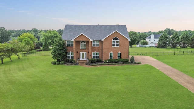 colonial home featuring a lawn