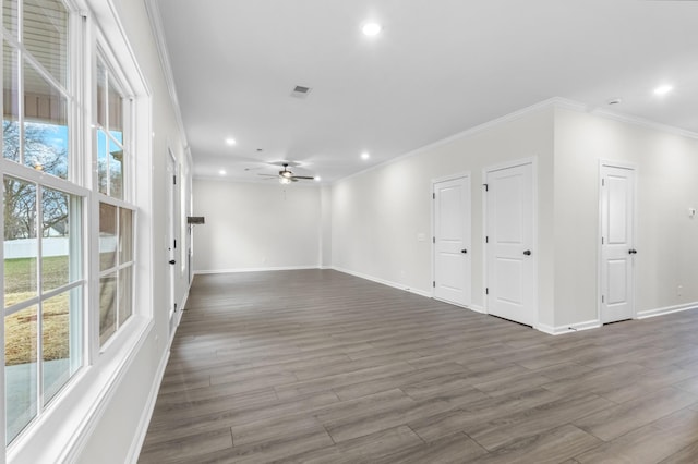 unfurnished room with crown molding, dark hardwood / wood-style floors, and ceiling fan