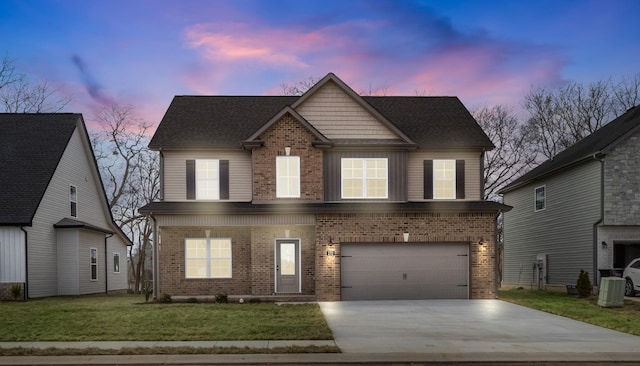 view of front of home with a garage and a yard