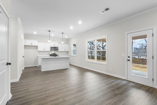 unfurnished living room with ornamental molding and dark hardwood / wood-style flooring