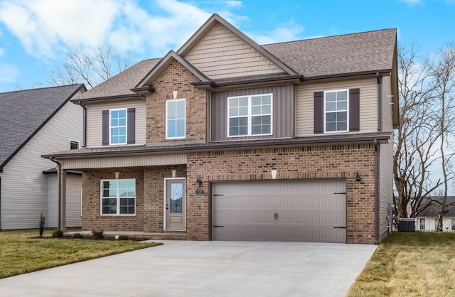 craftsman house with a front yard and a garage