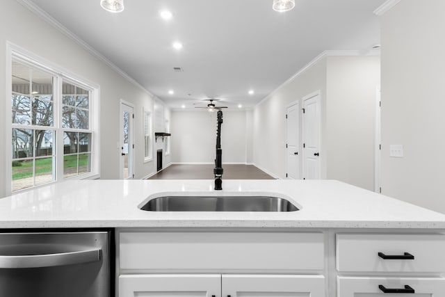 kitchen featuring dishwasher, sink, white cabinets, ceiling fan, and light stone counters