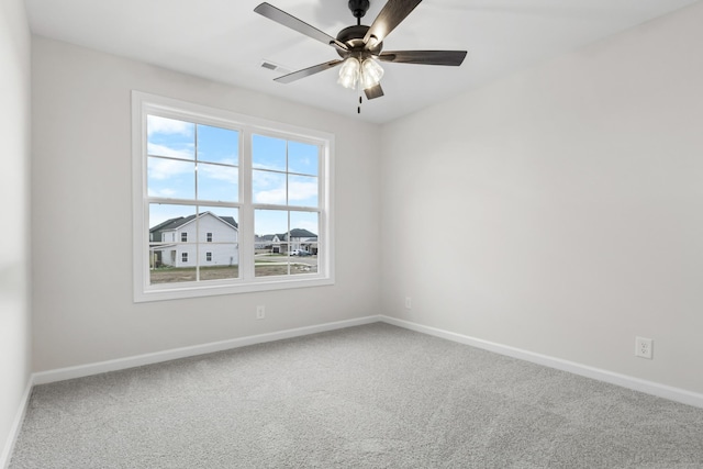 carpeted spare room featuring ceiling fan